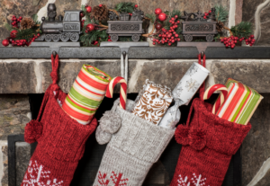 holiday stockings hanging above a fireplace